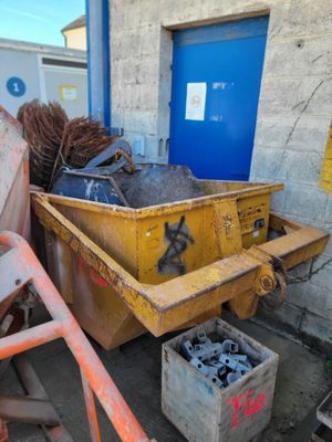 a yellow dumpster sitting in front of a blue door