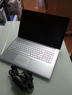 a laptop computer sitting on a table with a charger