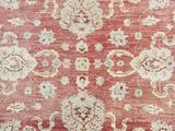 a red and white rug with a floral design on it