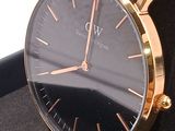 a black and gold watch sitting on a black box