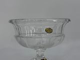 clear glass bowl with a gold button on the bottom