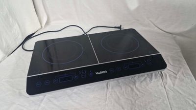 a black stove top with two burners on top of it
