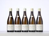six bottles of wine are lined up on a table