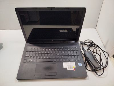 a laptop that is sitting on a table with a charger