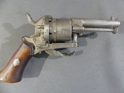 an old gun with a wooden handle on a table