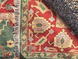 an image of a red and green area rug with a blue border