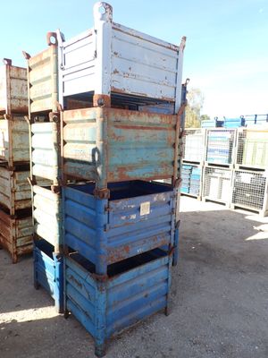 many crates stacked on top of each other in the dirt