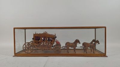 a wooden display case with a horse drawn carriage