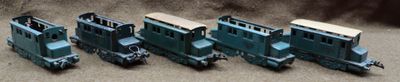 several toy trains are lined up in a row on the ground