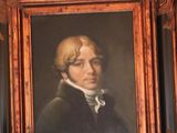 portrait of a man in a black coat in a wooden frame