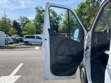 a white van with its door open in a parking lot