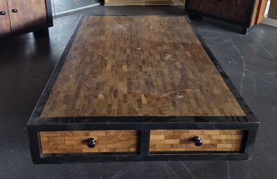 a coffee table with two drawers on it in the middle of a room