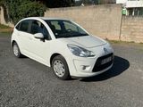 a picture of a small white car parked on the side of the road