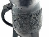 a silver vase that has a handle on top of it