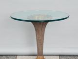 an image of a glass table with a gold base on a checkered floor