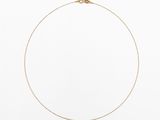 un collier en chaîne en or avec un fermoir en diamant sur fond blanc