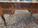a wooden desk with drawers on top of it