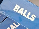 two boxes of balls sitting on top of each other