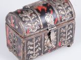 an ornately decorated box with red and black designs on it