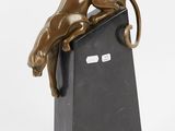 bronze sculpture of a cat on a black stand