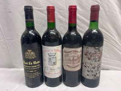 four bottles of wine are lined up on a white surface