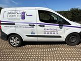 the van is parked on the side of the road in the parking lot