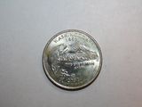 a silver coin with a picture of a bird on it