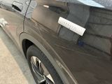 a black car with a sticker on the side of it