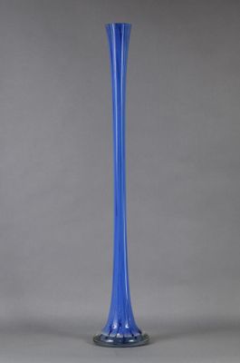 a blue glass vase on a gray background