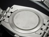 a watch that is sitting on a black surface