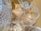 many glasses and cups sitting on the floor next to each other
