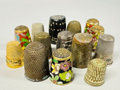 many different types of thimbles sitting on a white surface