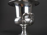 an image of a silver vase sitting on top of a table
