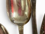 three spoons and two spoon spoons on a white surface
