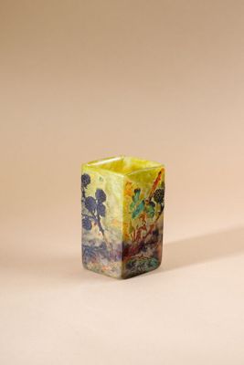 an image of a small square vase with a painting on it