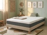 a bed that has a mattress on it in a room