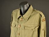a green jacket with buttons on a mannequin head