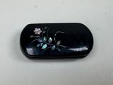 a black case with flowers on it sitting on a table