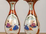 two vases that are sitting on a table