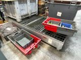 many containers that are sitting on a conveyor belt