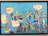 a painting of flowers in a black frame on the wall