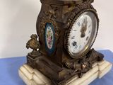 a clock that has a statue of a woman on top of it