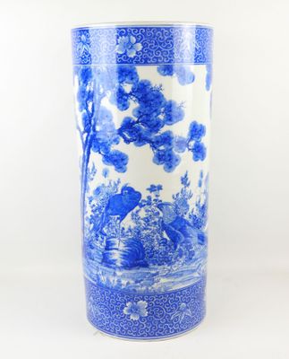 a blue and white vase with birds and flowers on it
