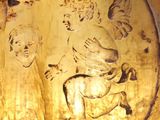 a close up of a gold plate with angels on it