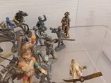 many figurines in a display case on a table
