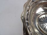 a silver plate that has a flower design on it