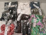 a lot of clothes that are wrapped in plastic bags