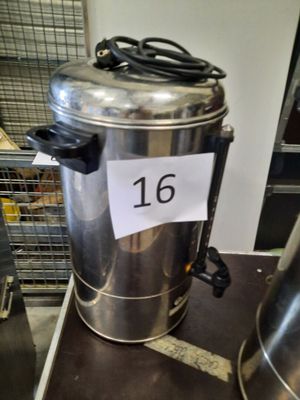 a metal container with a sign on it sitting on a table