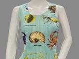 female mannequin wearing a blue top with various types of sea life
