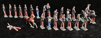 many figurines of people that are standing in a line